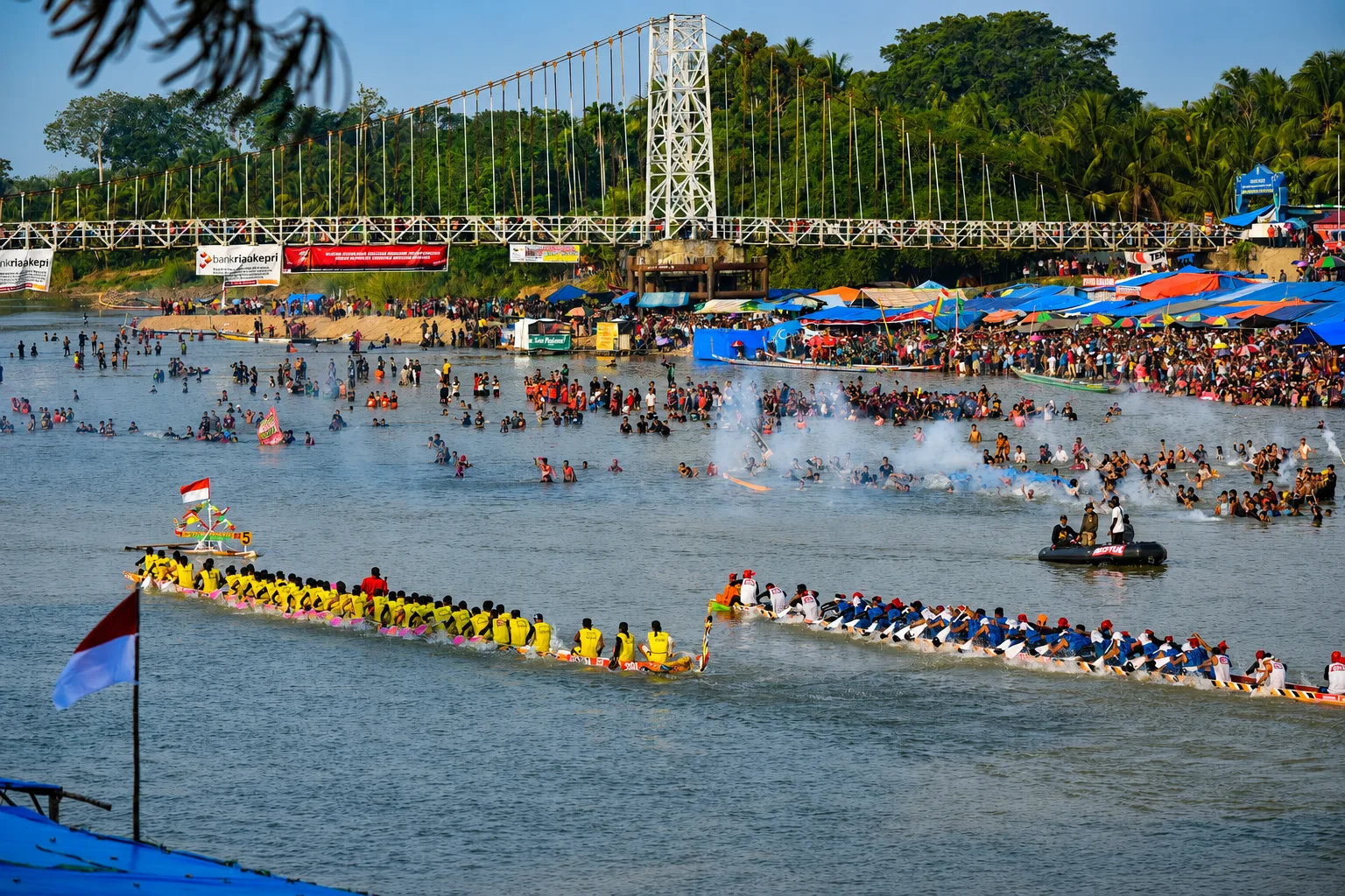 Long wooden jalur racing before crowds during Pacu Jalur in Kuantan Singingi.