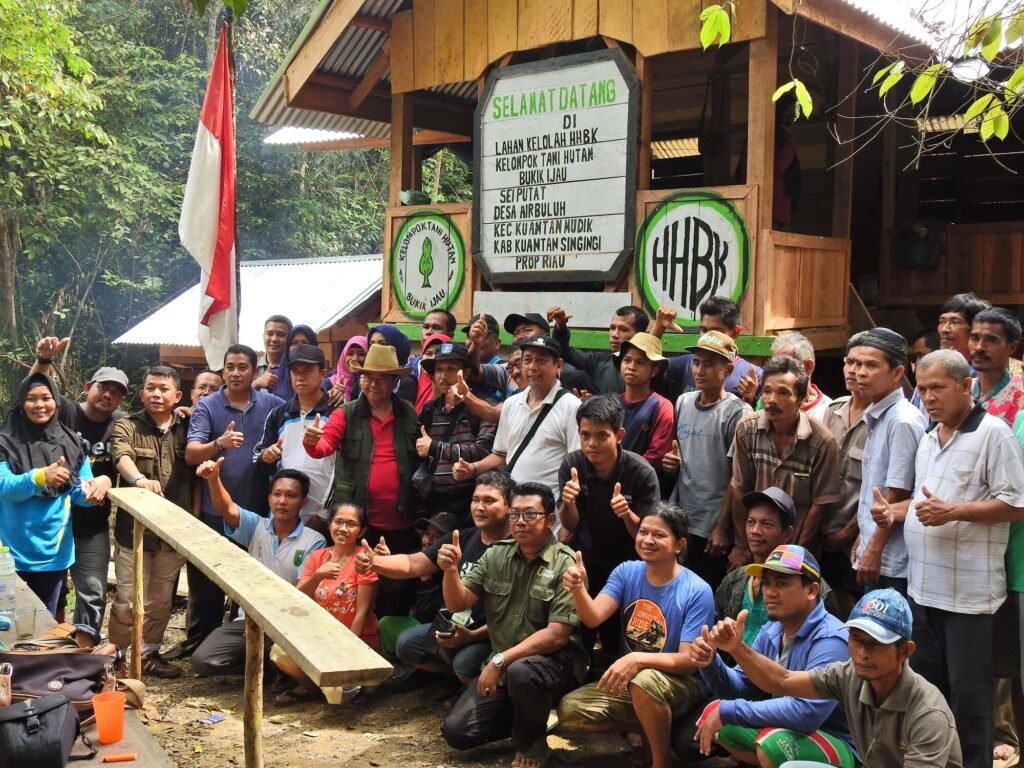 Members and partners of KTH Bukik Ijau gathered at the community forest management hut in Air Buluh