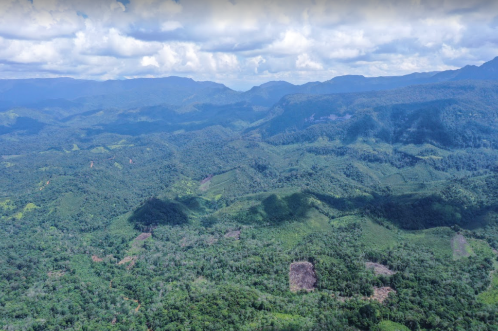 Forested mountain landscape surrounding Lubuk Bigau Village in Riau